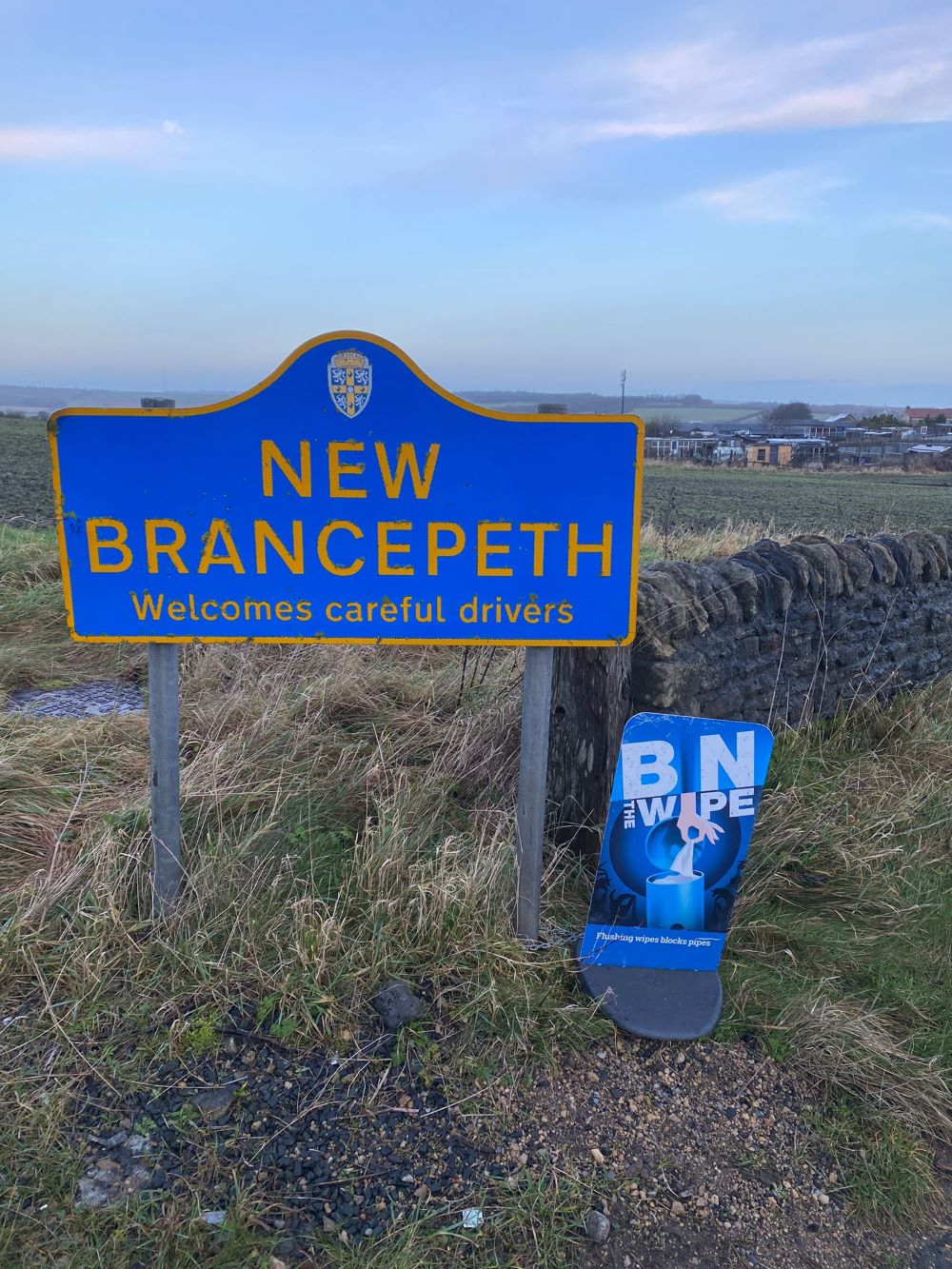New Brancepeth sign with a Bin the Wipe sign